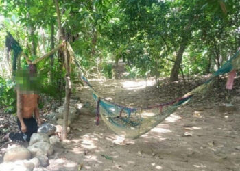 Joven se cuelga en la orilla de un río